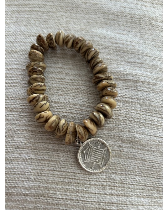 Pulsera de semillas con moneda elàstica